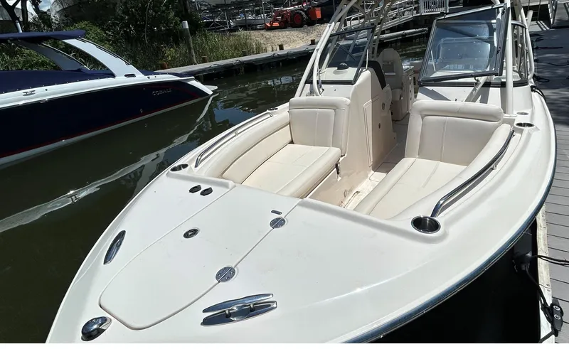 Slide: The Image of 2016 Grady-White Freedom 275 boat docked, featuring spacious seating and sleek design. - 19