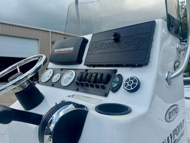 Slide: The Image of 2017 Blazer Bay 2170 boat dashboard with steering wheel and control panel. - 14