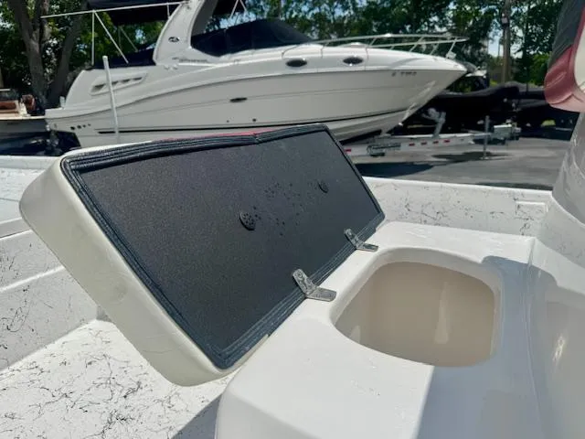 Slide: The Image of Open storage compartment on 2017 Blazer Bay 2170 boat with yacht in background. - 24