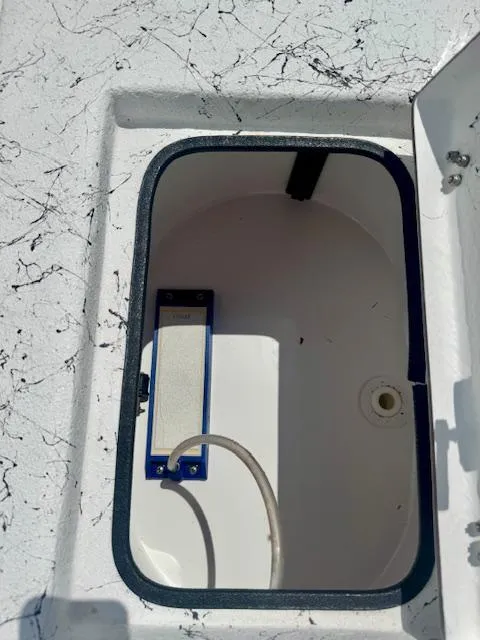 Slide: The Image of Open storage compartment in 2017 Blazer Bay 2170 boat, featuring a white interior and blue trim. - 31