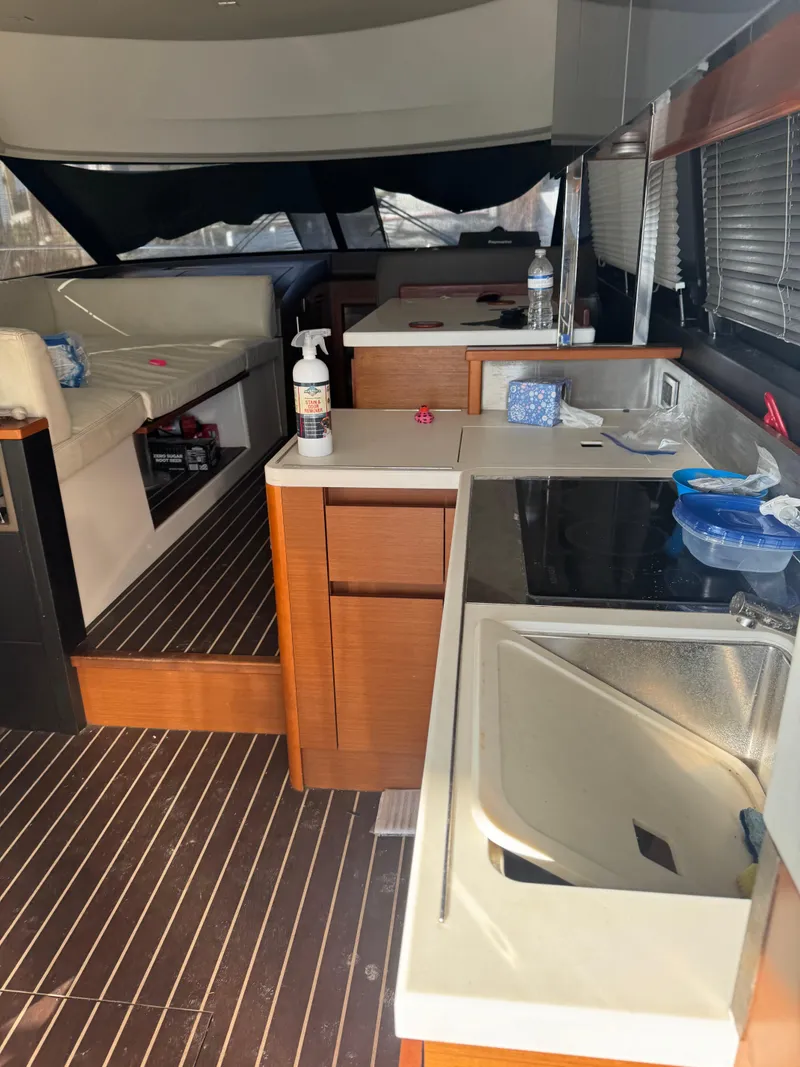 Slide: The Image of Interior of a 2015 Prestige 450 Fly yacht with modern kitchen and seating area. - 11