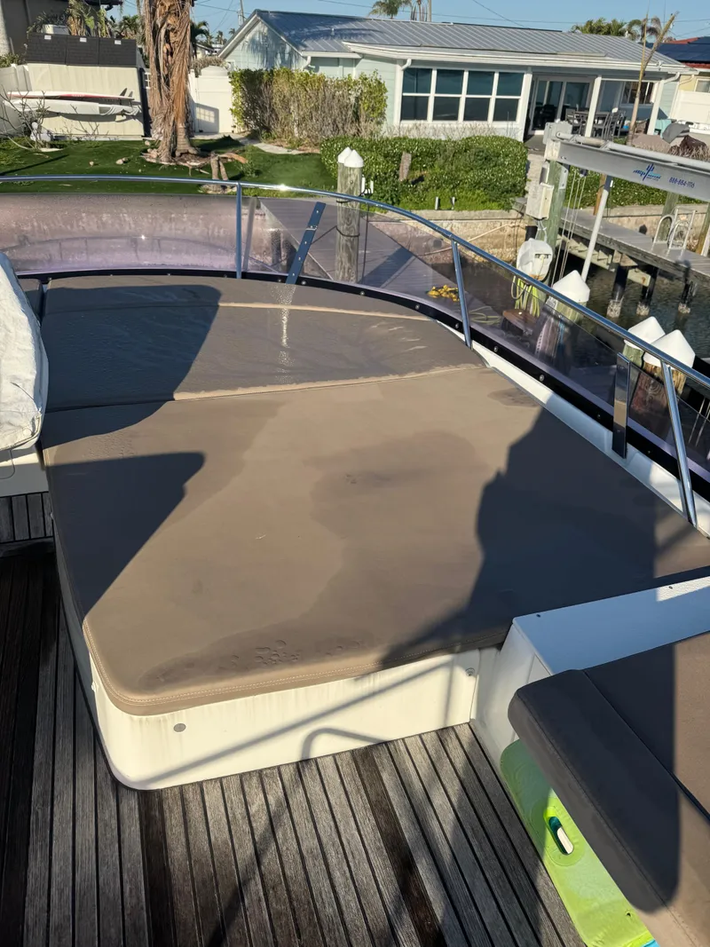 Slide: The Image of Prestige 450 Fly 2015 yacht deck with cushioned seating and waterfront view. - 14