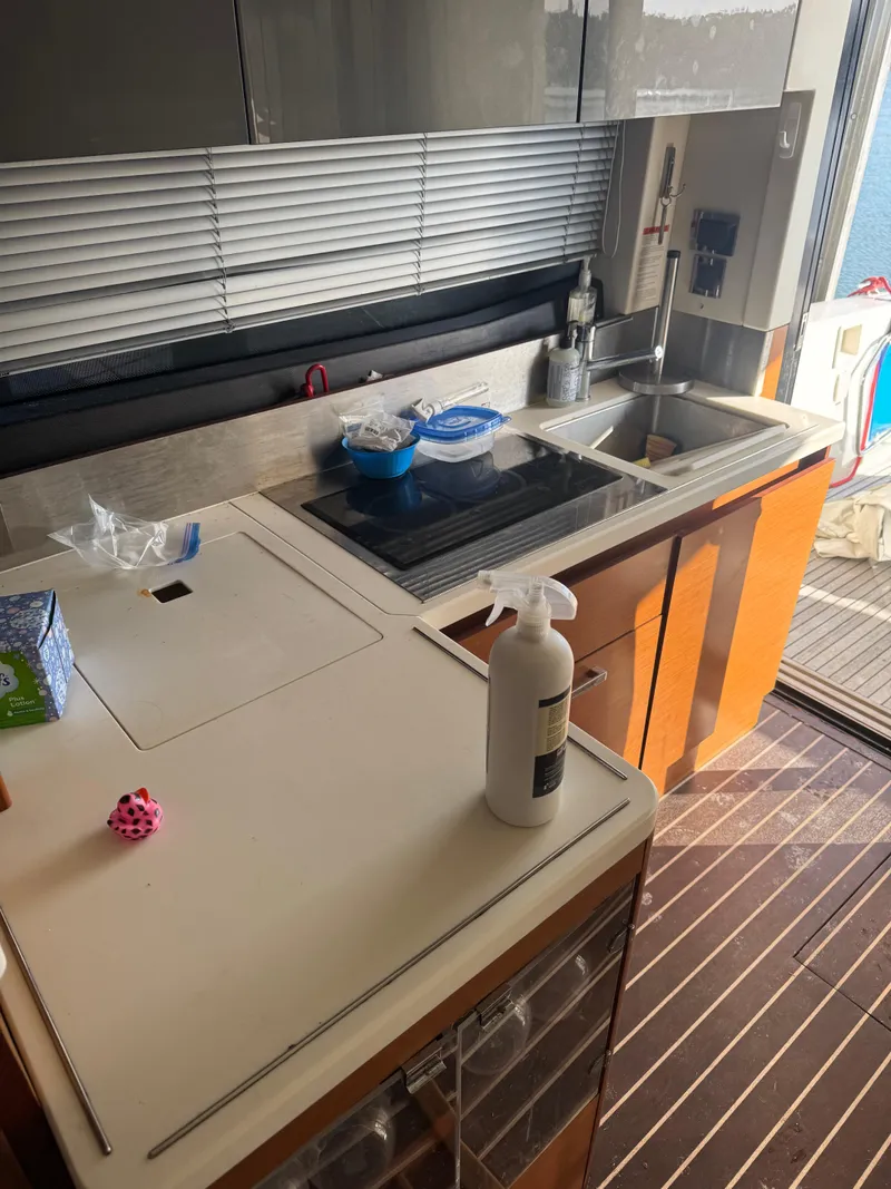 Slide: The Image of Modern kitchen interior on a 2015 Prestige 450 Fly yacht, featuring sleek countertops and appliances. - 15