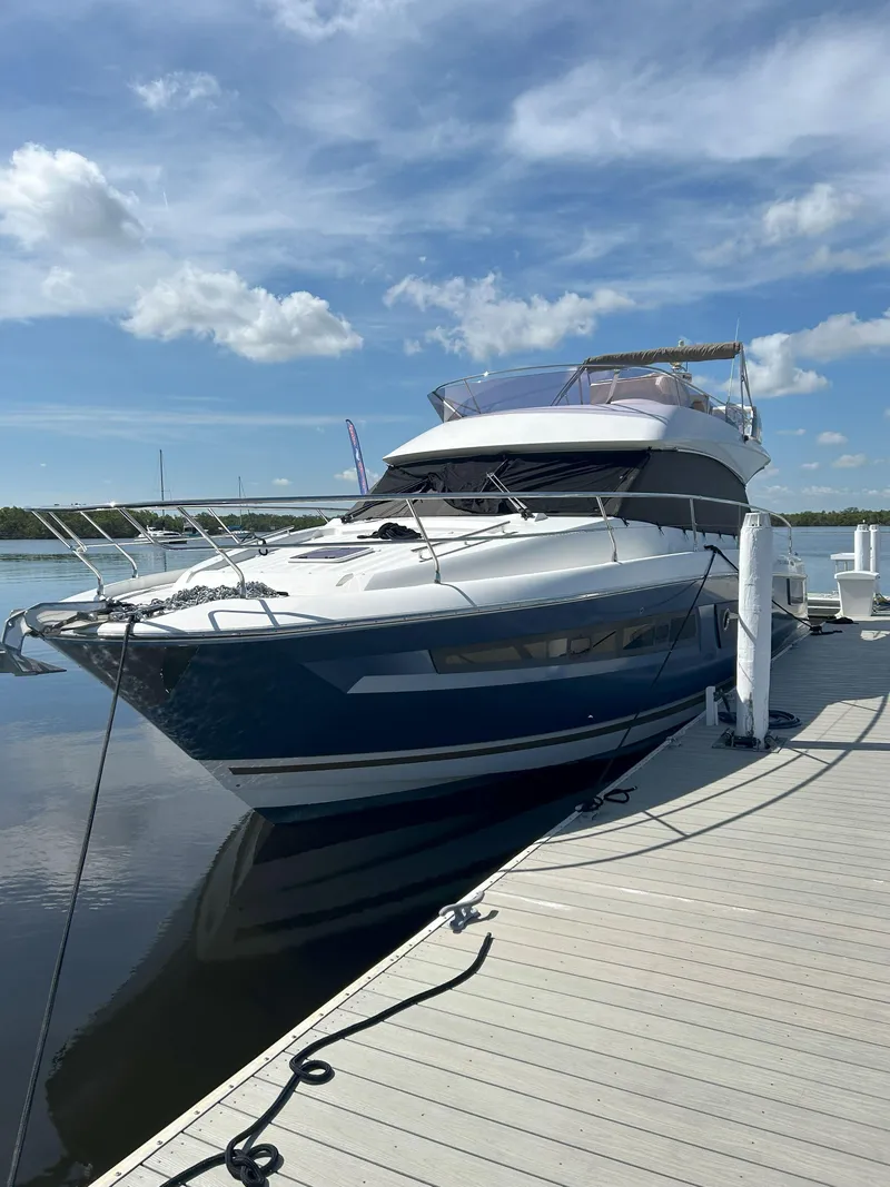 Slide: The Image of 2015 Prestige 450 Fly yacht docked under a clear blue sky. - 2