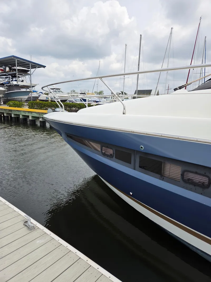 Slide: The Image of 2015 Prestige 450 Fly yacht docked at marina, cloudy sky background. - 5