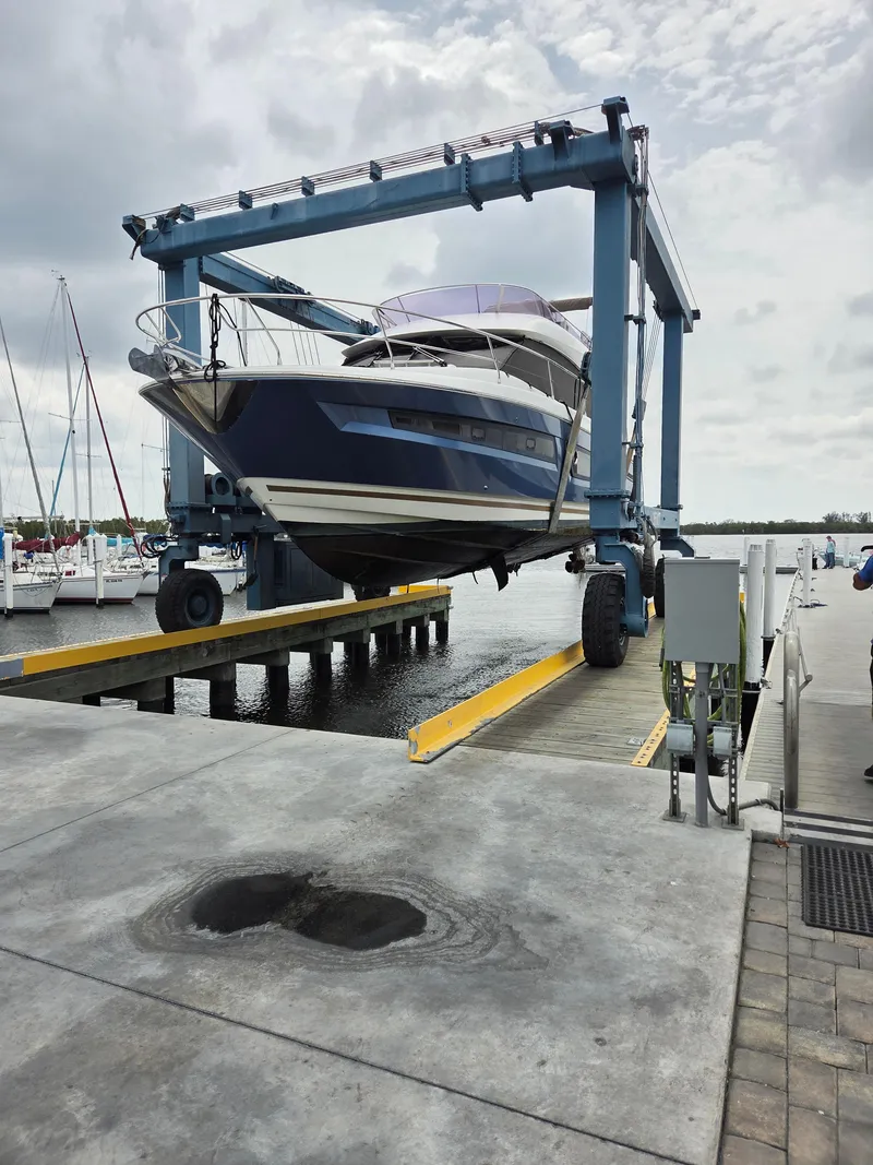 Slide: The Image of 2015 Prestige 450 Fly yacht on a lift at a marina dock. - 8