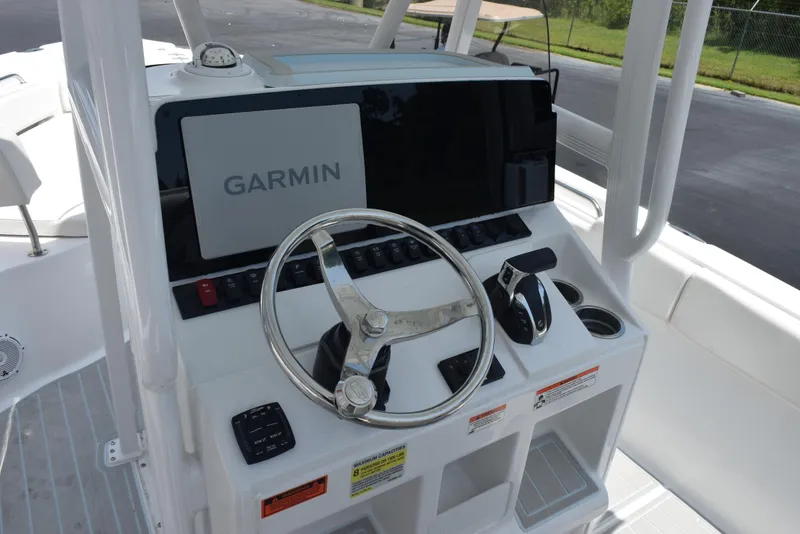 Slide: The Image of 2023 Sea Hunt Ultra 234 boat console with Garmin navigation system and steering wheel. - 11