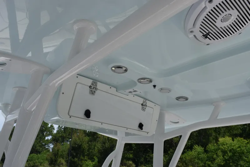 Slide: The Image of 2023 Sea Hunt Ultra 234 boat interior ceiling with speakers and storage compartment. - 12