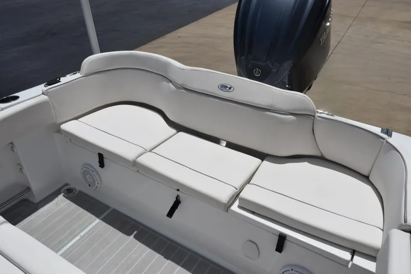 Slide: The Image of 2023 Sea Hunt Ultra 234 boat with white cushioned seating and Yamaha outboard motor. - 13