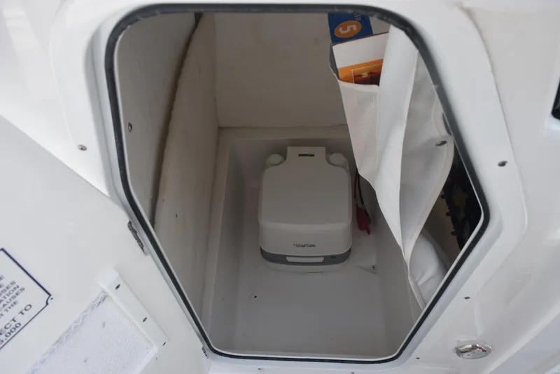 Slide: The Image of Storage compartment in 2023 Sea Hunt Ultra 234 boat with portable toilet. - 15