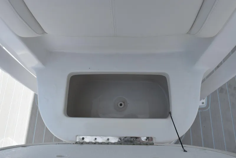 Slide: The Image of 2023 Sea Hunt Ultra 234 boat storage compartment, white interior, top view. - 16