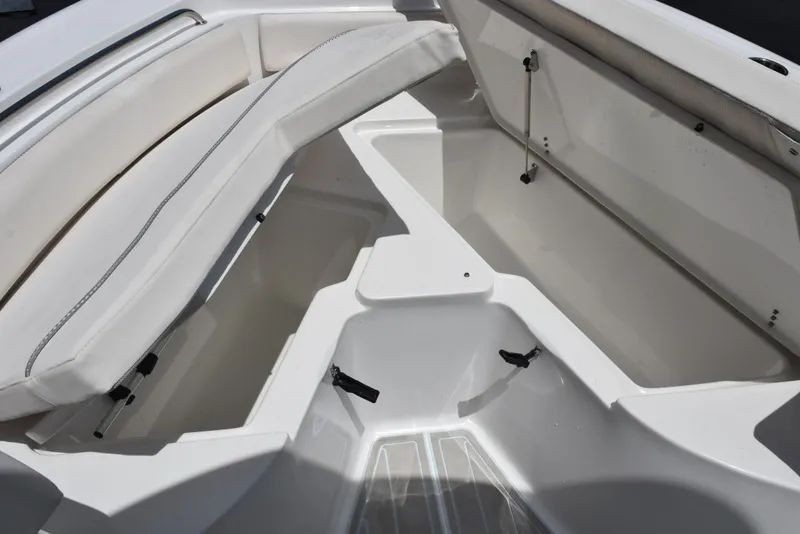 Slide: The Image of 2023 Sea Hunt Ultra 234 boat interior with spacious seating and storage compartments. - 17