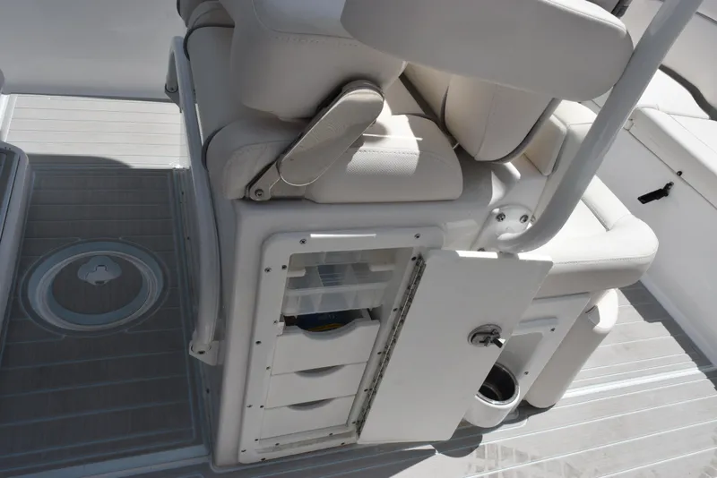 Slide: The Image of 2023 Sea Hunt Ultra 234 boat interior with storage compartments and seating. - 18