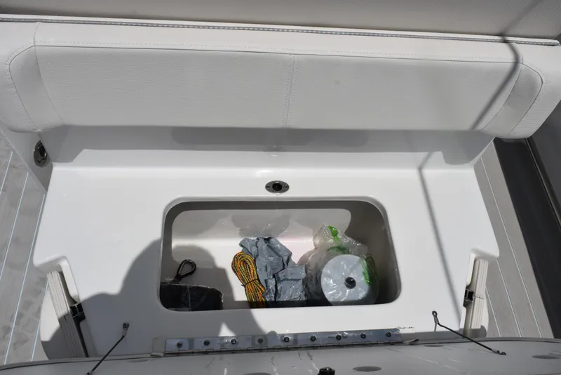 Slide: The Image of Storage compartment on 2023 Sea Hunt Ultra 234 boat with various items inside. - 19