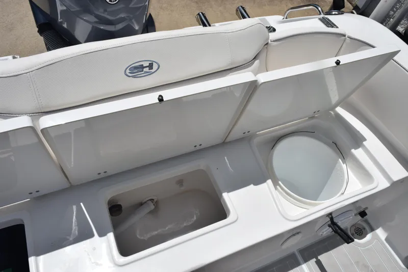 Slide: The Image of 2023 Sea Hunt Ultra 234 boat interior with storage compartments and seating. - 22