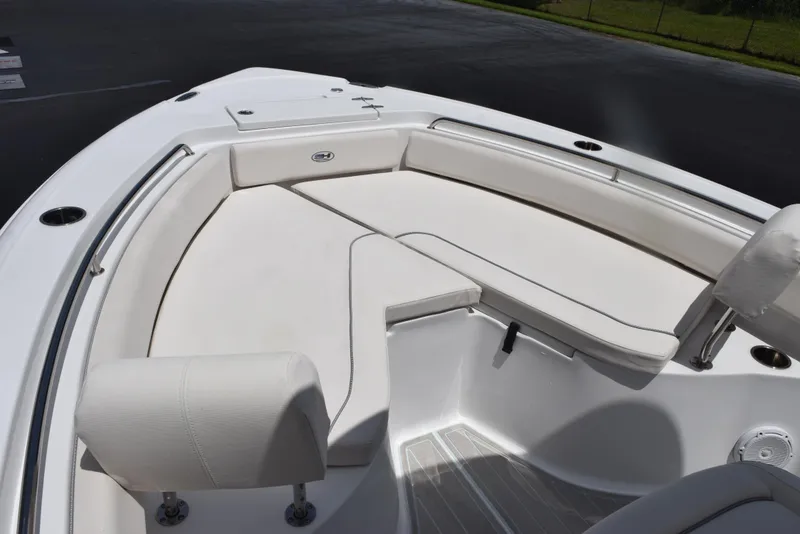 Slide: The Image of 2023 Sea Hunt Ultra 234 boat interior with white cushioned seating. - 8