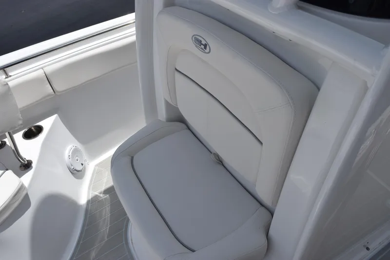 Slide: The Image of 2023 Sea Hunt Ultra 234 boat seat with white upholstery and sleek design. - 9
