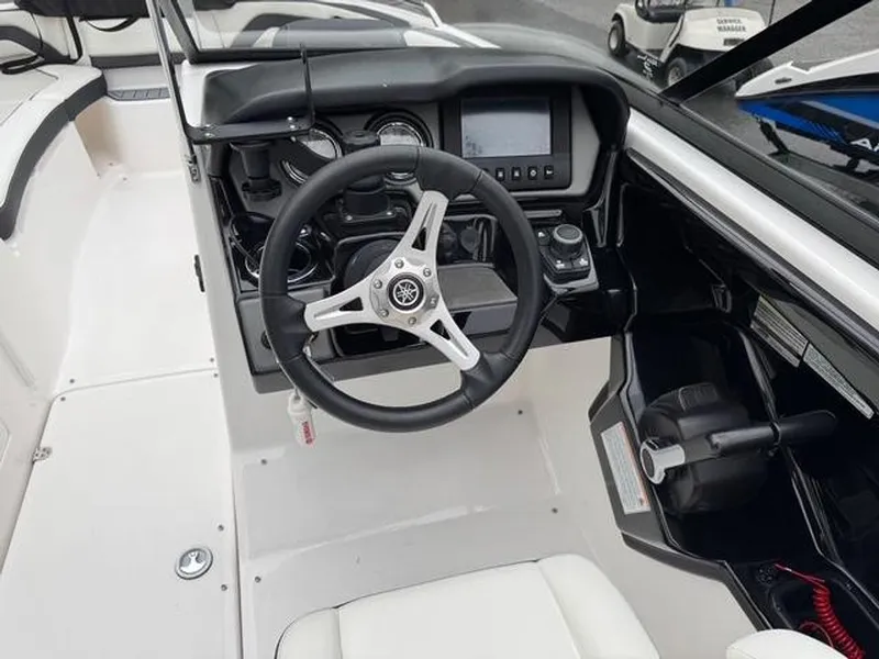 Slide: The Image of 2016 Yamaha Boats 242 Limited S dashboard with steering wheel and controls. - 10