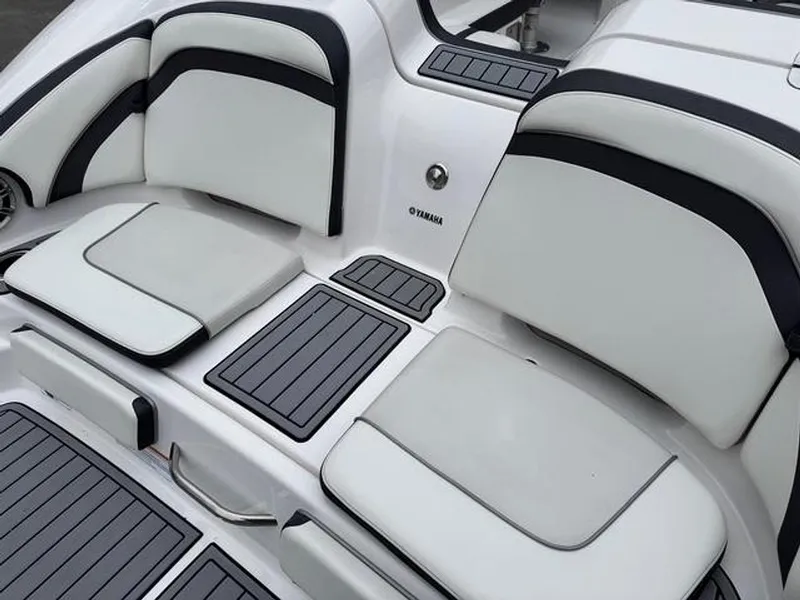Slide: The Image of 2016 Yamaha Boats 242 Limited S interior seating with sleek white and black design. - 4