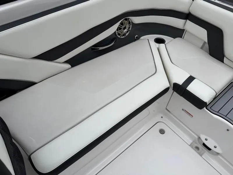 Slide: The Image of 2016 Yamaha Boats 242 Limited S interior seating with sleek white and black design. - 7