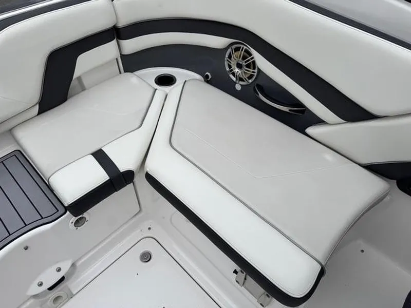 Slide: The Image of 2016 Yamaha Boats 242 Limited S interior seating with sleek white and black design. - 8