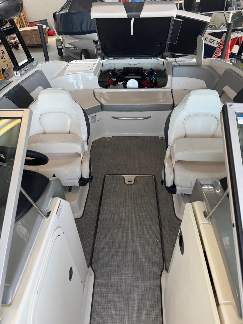Slide: The Image of 2021 Chaparral 23ssi boat interior with open engine compartment and seating. - 10