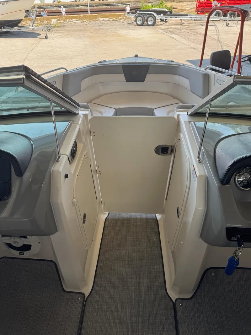 Slide: The Image of 2021 Chaparral 23ssi boat interior with open bow seating and dashboard view. - 11