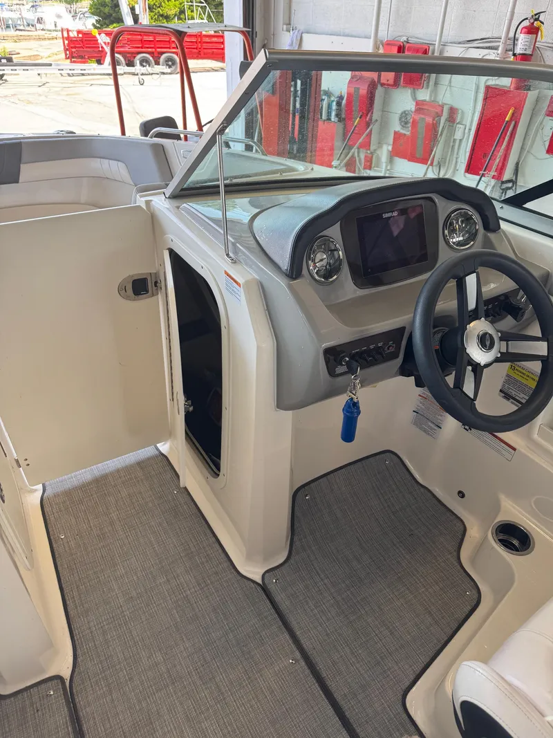 Slide: The Image of 2021 Chaparral 23ssi boat interior with steering wheel and dashboard controls. - 12
