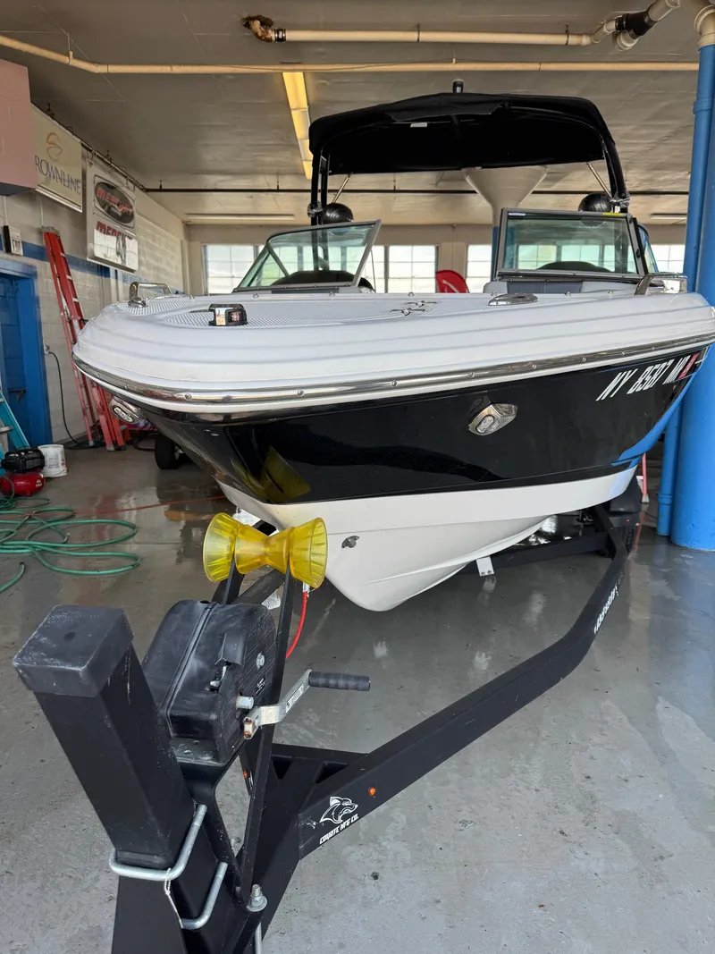 Slide: The Image of 2021 Chaparral 23ssi boat on trailer in garage setting. - 3