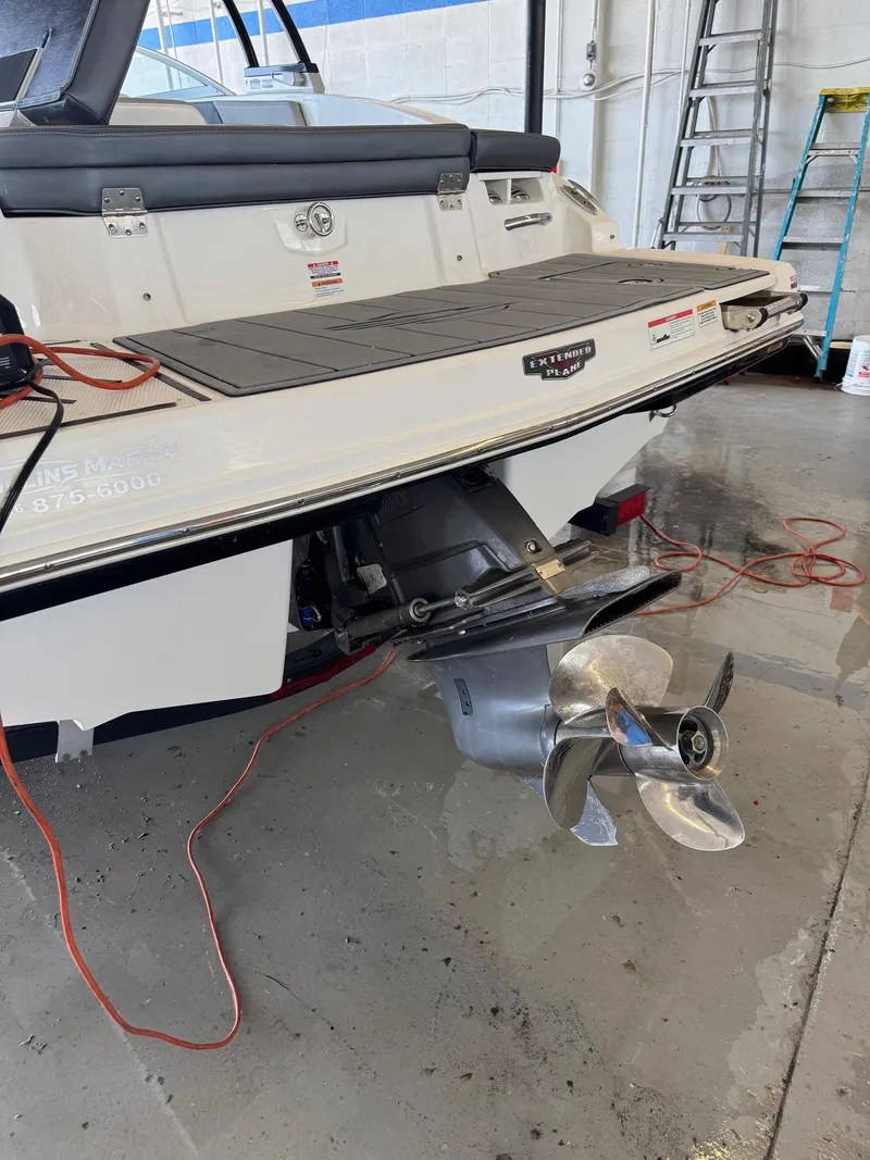 Slide: The Image of 2021 Chaparral 23ssi boat with propeller, in a garage setting. - 4
