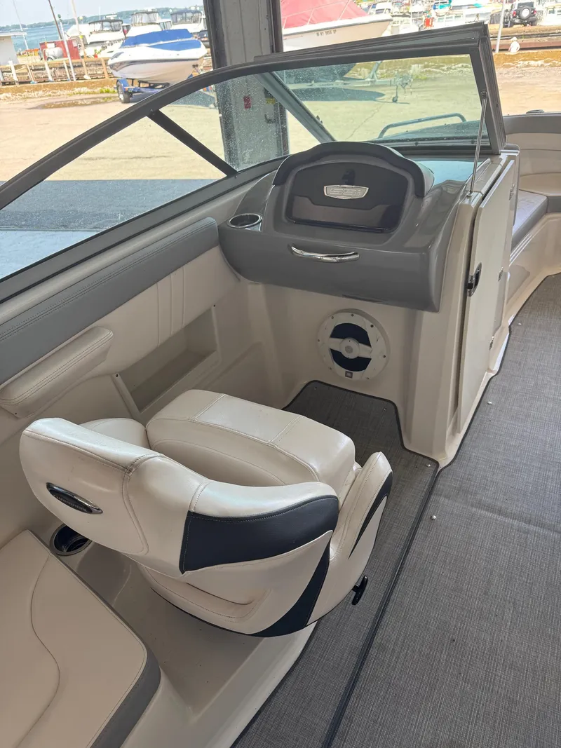 Slide: The Image of 2021 Chaparral 23ssi boat interior with helm and seating area. - 8
