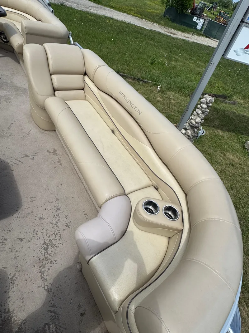 Slide: The Image of 2008 Bennington 2275RLi boat interior with beige seating and cup holders. - 10