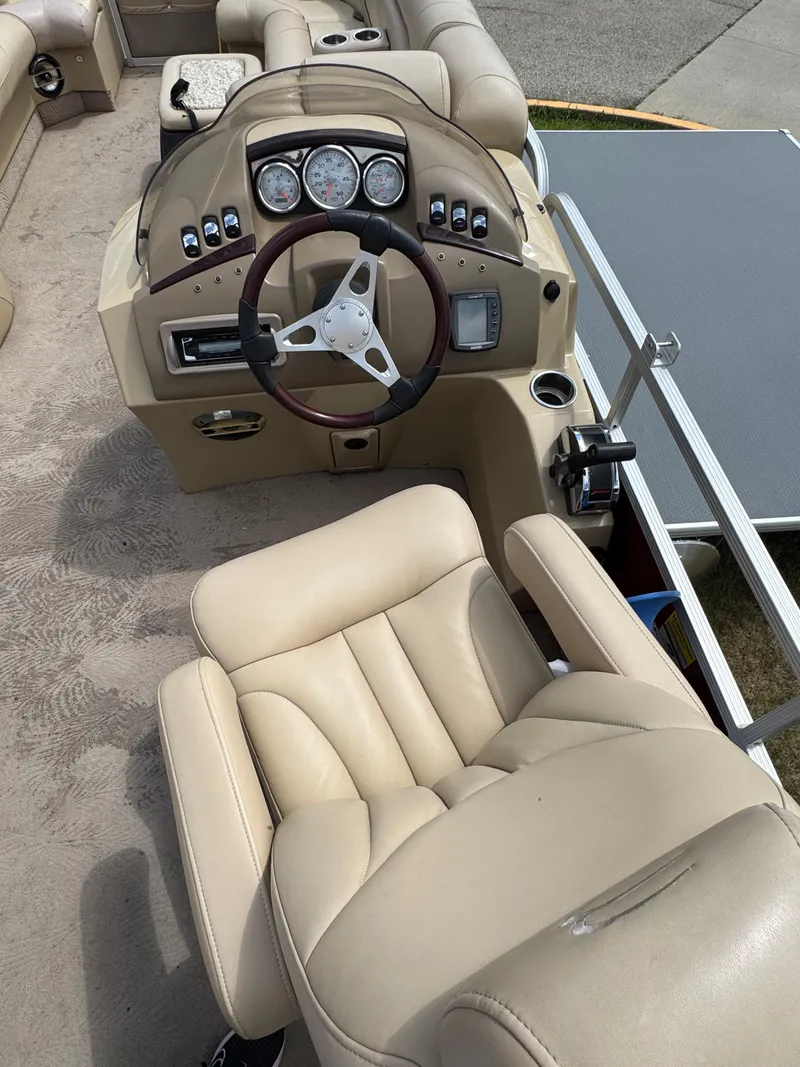 Slide: The Image of 2008 Bennington 2275RLi boat interior with beige seating and steering console. - 13