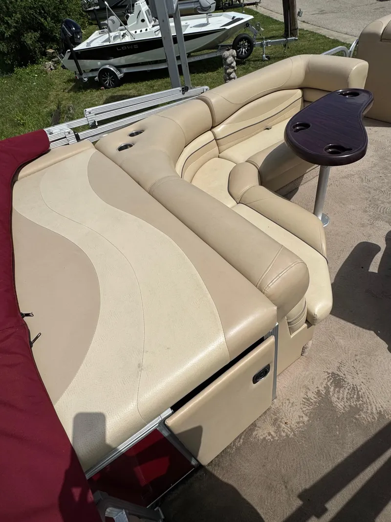 Slide: The Image of 2008 Bennington 2275RLi pontoon boat with beige seating and a small table. - 15