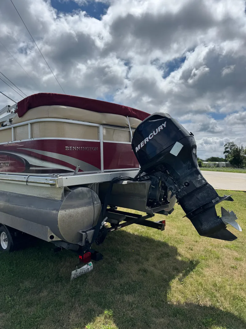 Slide: The Image of 2008 Bennington 2275RLi pontoon boat with Mercury outboard motor on grassy area. - 4