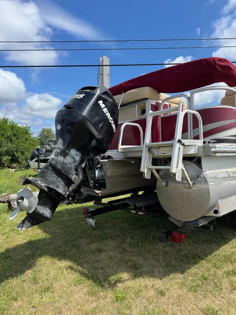 Slide: The Image of 2008 Bennington 2275RLi pontoon boat with Mercury outboard motor on grassy area. - 5