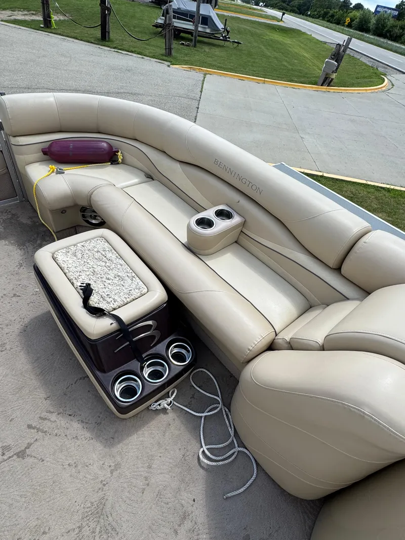 Slide: The Image of 2008 Bennington 2275RLi boat interior with beige seating and cup holders. - 9