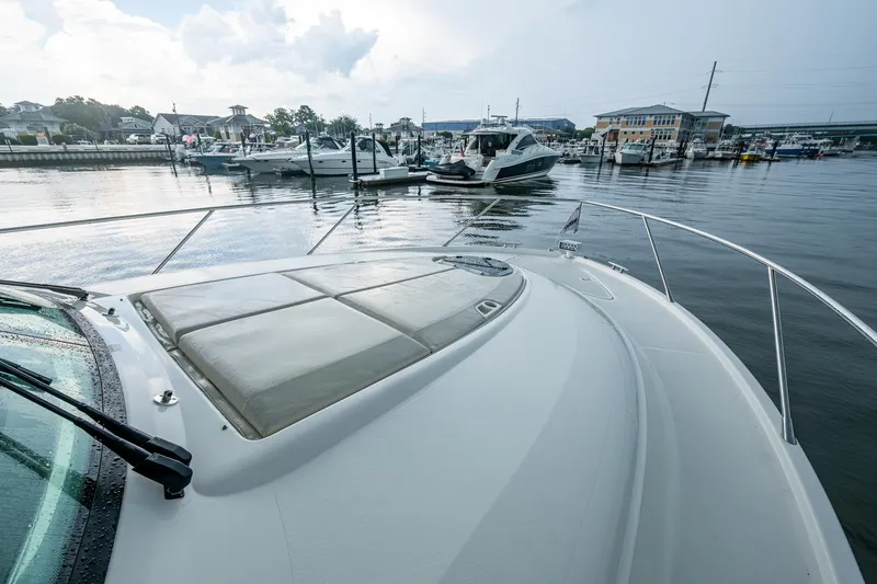 Slide: The Image of 2020 Tiara Yachts C44 Coupe docked in a marina, showcasing sleek design and luxury. - 25