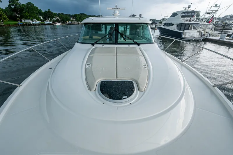 Slide: The Image of 2020 Tiara Yachts C44 Coupe on water, showcasing sleek deck design and marina backdrop. - 26