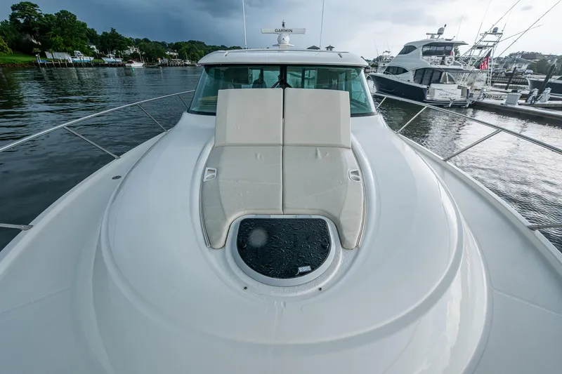 Slide: The Image of 2020 Tiara Yachts C44 Coupe on water, featuring sleek deck design and luxurious seating. - 27