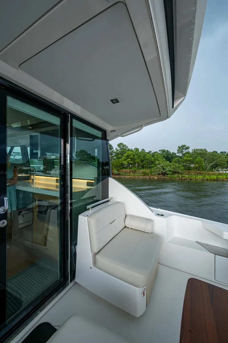 Slide: The Image of 2020 Tiara Yachts C44 Coupe, elegant seating area with scenic water view. - 32