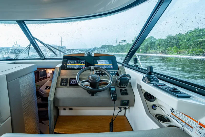 Slide: The Image of 2020 Tiara Yachts C44 Coupe helm with modern controls and scenic water view. - 36
