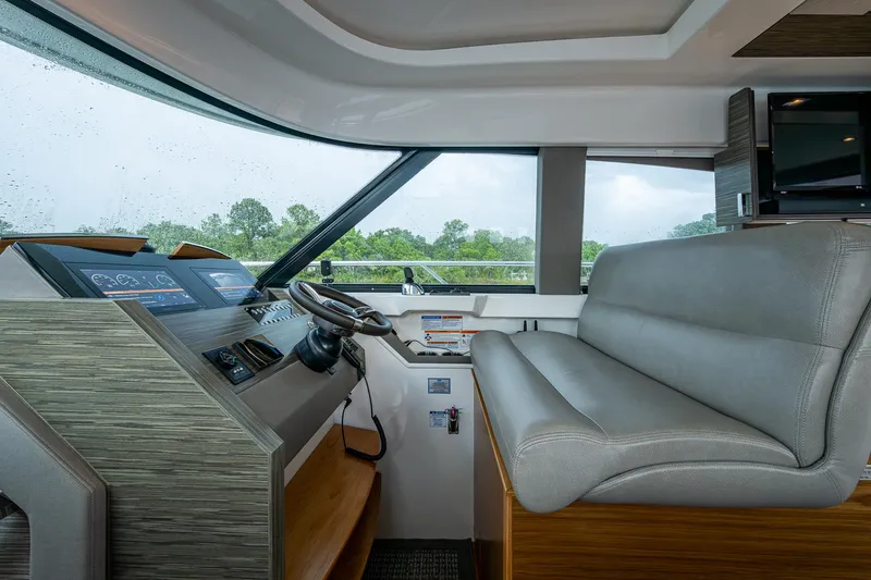 Slide: The Image of 2020 Tiara Yachts C44 Coupe helm with modern controls and comfortable seating. - 38
