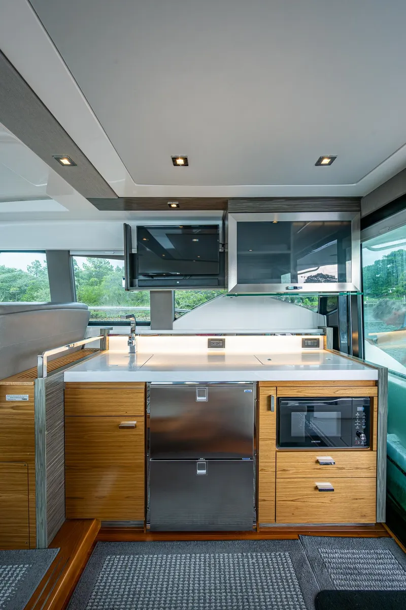 Slide: The Image of 2020 Tiara Yachts C44 Coupe interior kitchen with modern appliances and sleek design. - 49