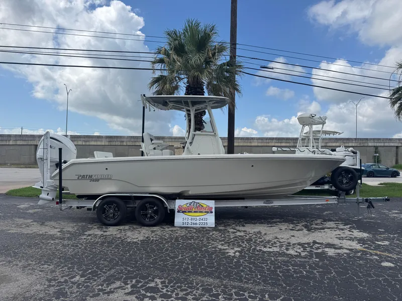The Image of 2025 Pathfinder 2400 TRS boat on trailer, parked outdoors under a cloudy sky. - 1