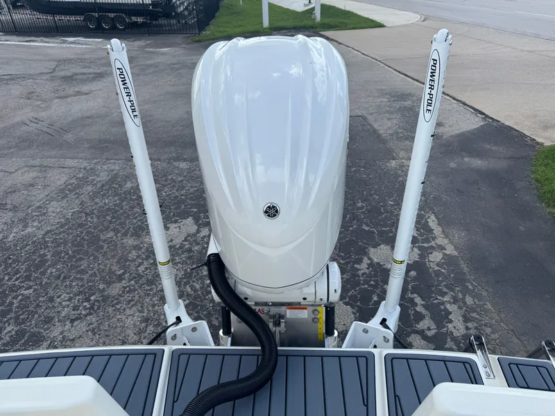 Slide: The Image of 2025 Pathfinder 2400 TRS boat with Power-Pole anchors and outboard motor, viewed from the rear. - 11