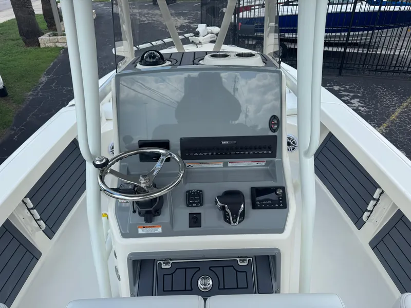 Slide: The Image of 2025 Pathfinder 2400 TRS boat console with steering wheel and controls. - 12