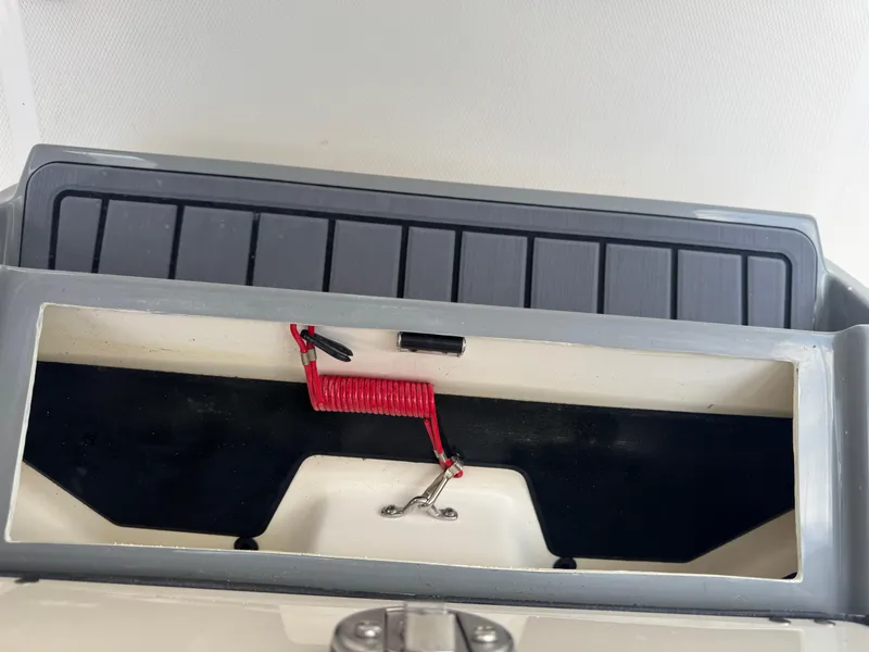 Slide: The Image of Storage compartment of 2025 Pathfinder 2400 TRS boat with red safety cord. - 17