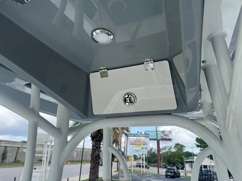 Slide: The Image of 2025 Pathfinder 2400 TRS boat T-top storage compartment with latch and light. - 18