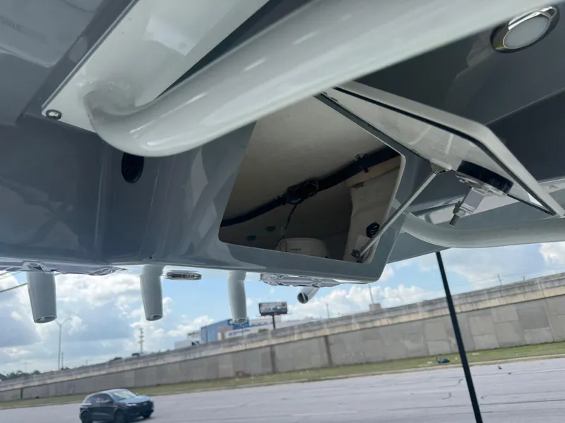 Slide: The Image of 2025 Pathfinder 2400 TRS boat underside view with open hatch, showcasing interior components. - 20